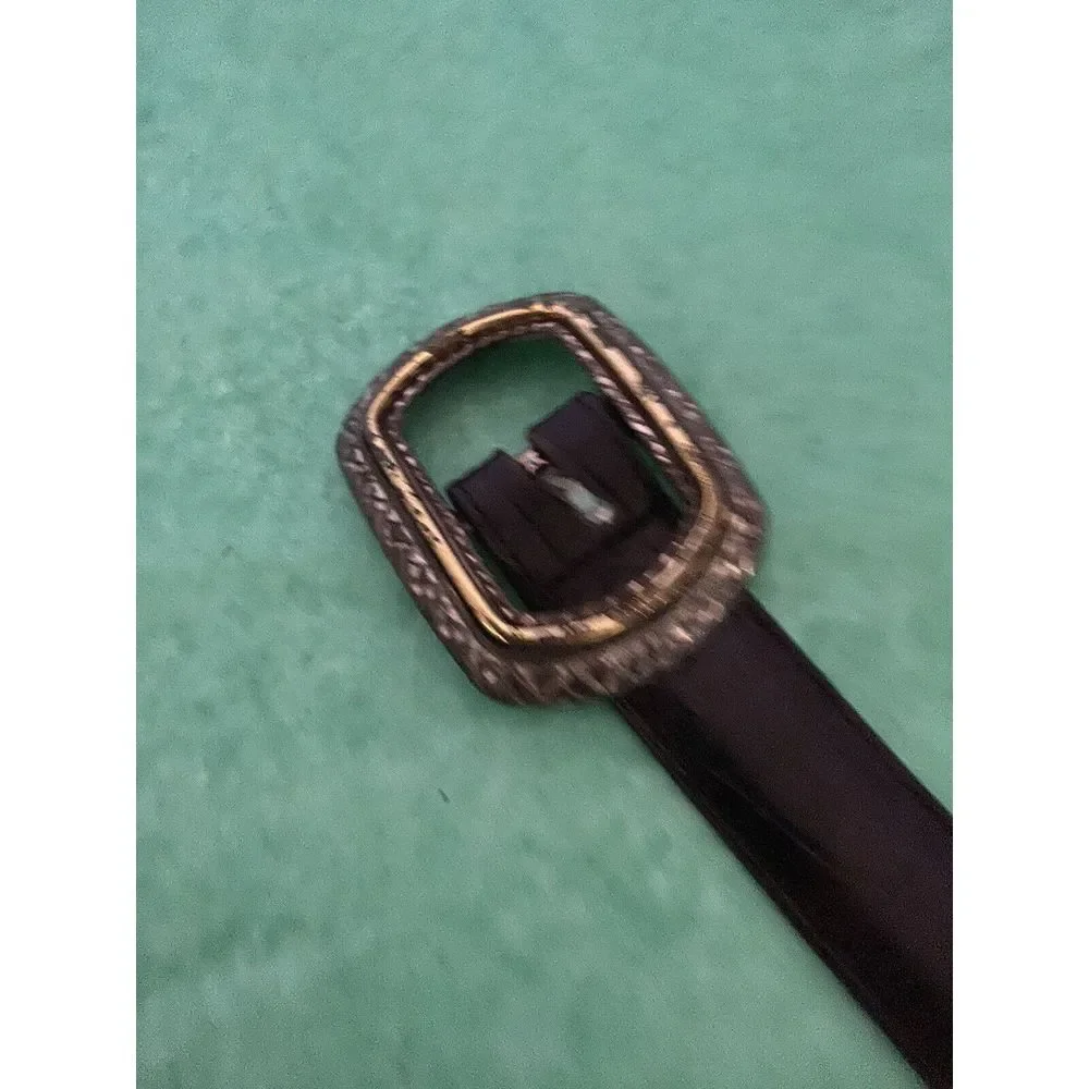 Ladies leather reversible belt black and brown with embellishments. Size med/30.